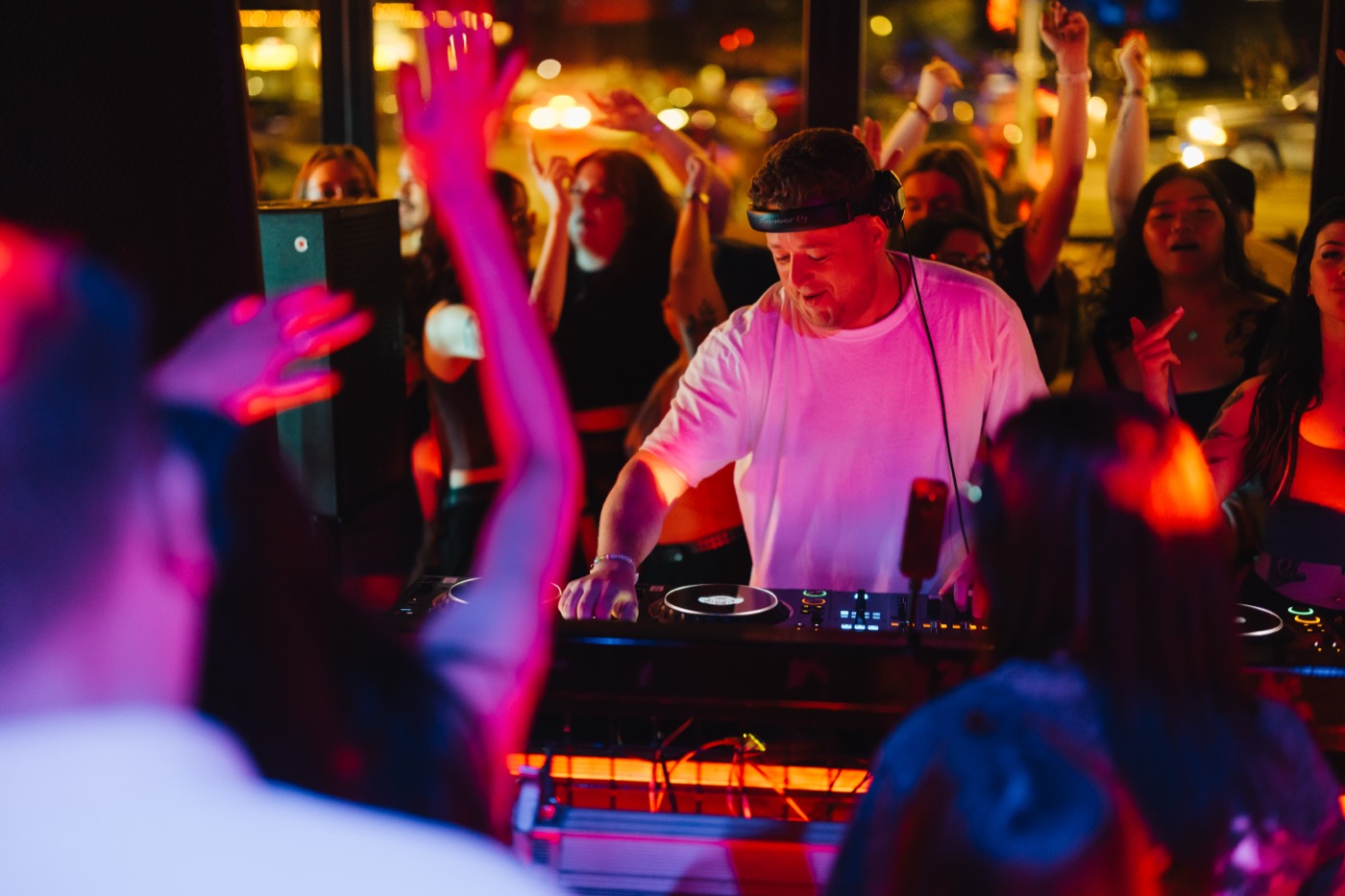 Harrison DJing to a busy Canadian club crowd