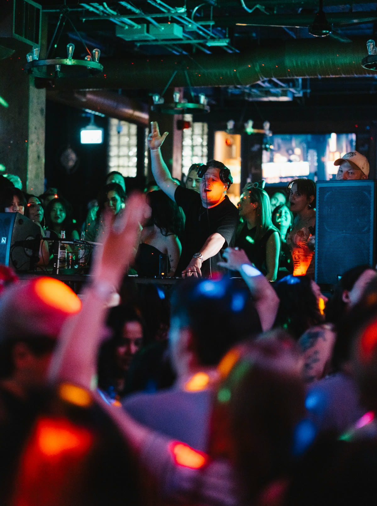Harrison performing to a packed crowd, hands raised